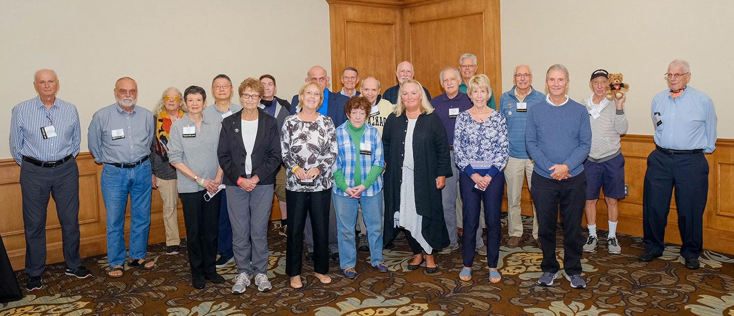 A group of older Oakland University alumni, posing for a group photo.