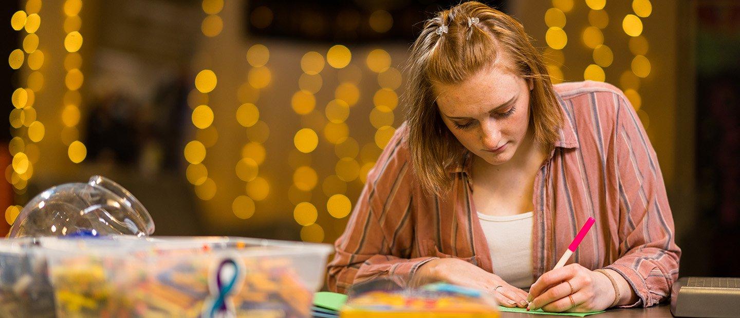 woman writing on cards