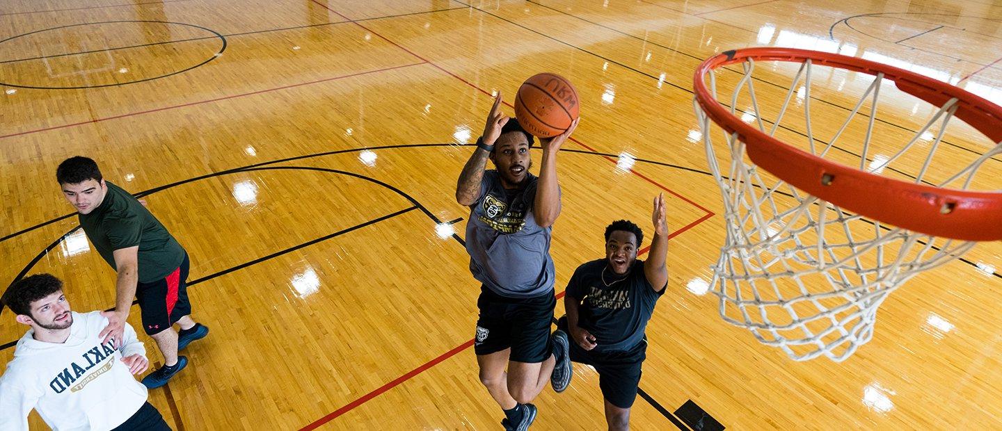 An aerial photo of men playing basketball in the recreation center.